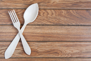 Set of wood spoon and fork on wooden table