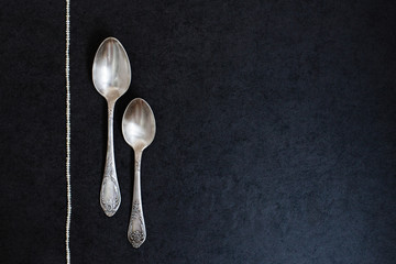 Two silver spoons with pearls