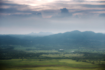 green mountain with fog and cloud sky