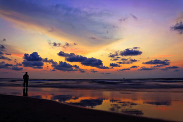 Man standing on a Beach at Sunset