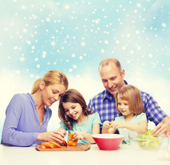 happy family with two kids making dinner at home