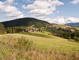 Fotobehang meadow, hills and Velke Borové village in Slovakia © honza28683
