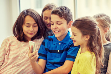 group of school kids taking selfie with smartphone