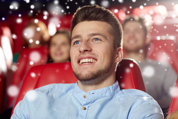 happy young man watching movie in theater