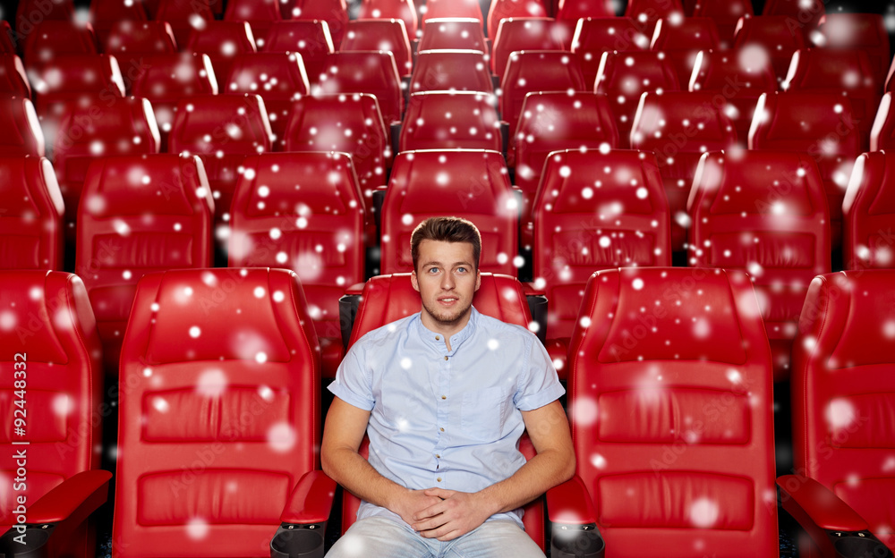 Wall mural happy young man watching movie in theater