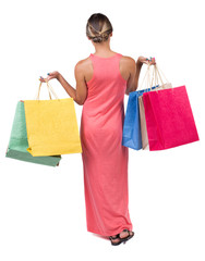 back view of going  woman  in  dress woman with shopping bags .