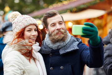 couple taking selfie with smartphone in old town