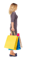 back view of woman with shopping bags .