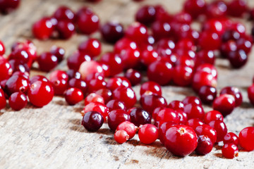 Fresh cranberry on old wooden table, selective focus