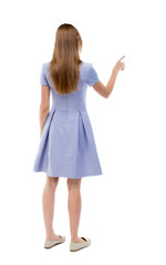 Fototapeta premium back view of young woman presses down on something.