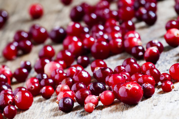 Fresh cranberry on old wooden table, selective focus