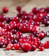Fresh cranberry on old wooden table, selective focus