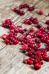 Fresh cranberry on old wooden table, selective focus