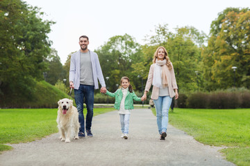 happy family with labrador retriever dog in park