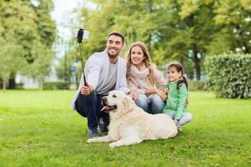 happy family with dog taking selfie by smartphone