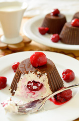 Homemade custard ice cream, covered with chocolate and cherries