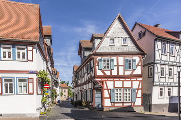 Fototapeta na wymiar old timbered medieval houses in Butzbach, Germany under blue sk
