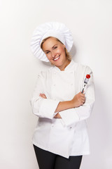 Woman chef showing a sign perfect, with tomato on fork, over whi