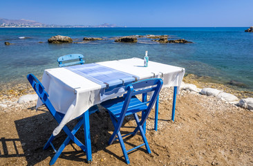Fototapeta na wymiar Blue restaurant table on the sea coast
