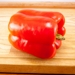 red fresh peppers on cutting board