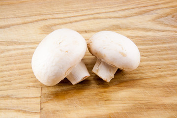 Champignon mushrooms on wooden board