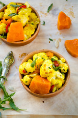 Cauliflower curry with pumpkin, paprika and arugula