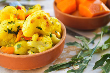 Cauliflower curry with pumpkin, paprika and arugula