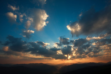 Dawn over the mountains in a cloudy sky, nature background