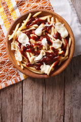 french fries with gravy and cheese. vertical top view
