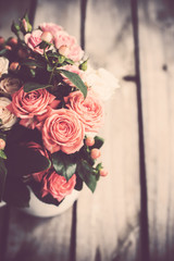 Bouquet of roses in vintage coffee pot