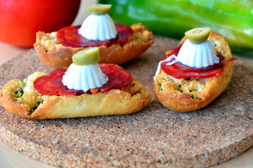 Italian bruschetta bread with salami and mozzarella on a plate