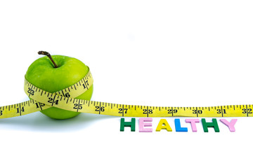 Apple wrapped with measuring tape on white background. Healthy diet concept. Selective focus.