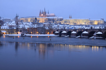 Night snowy Prague gothic Castle and Charles Bridge, Czech Republic