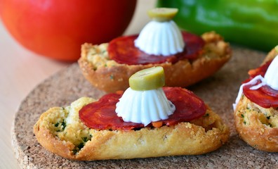 Italian bruschetta bread with salami and mozzarella on a plate