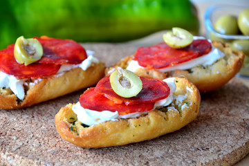 Fresh Italian Bruschetta With Mozzarella And Salami On A Wooden Table