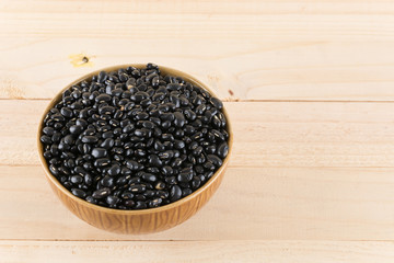 black beans on wood background