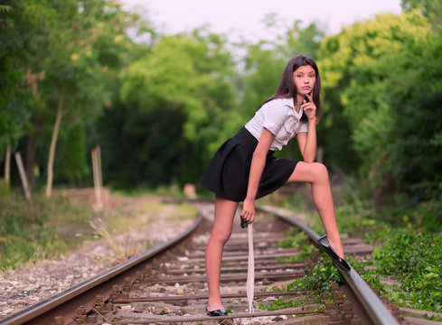 Girl posing on the railway line