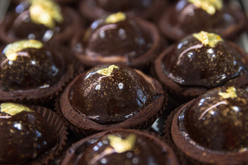 Chocolate candies with a gold decoration closeup