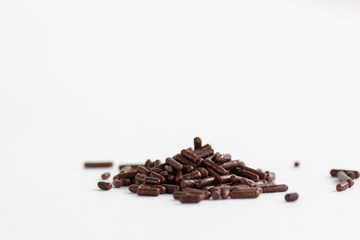 Chocolate sprinkles on a white background 