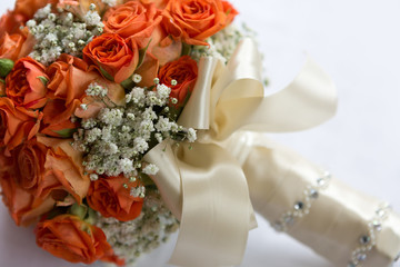 Wedding bouquet made of orange roses on white