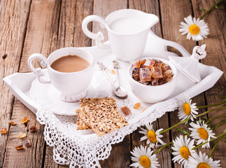 Coffee with milk and cookies on a tray. Romantic Breakfast with daisies.selective focus
