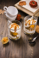 Pumpkin dessert in glass cups. Layered pumpkin tiramissu. Vintage style. Selective focus