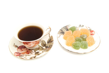 Obraz na płótnie Canvas cup of tea and fruit candies