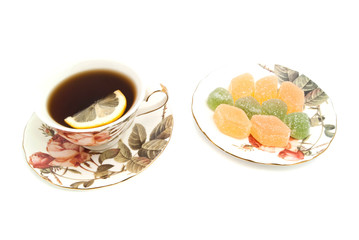 cup of tea with lemon and fruit candies