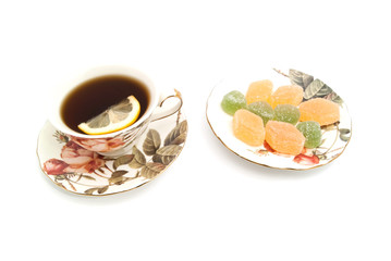 cup of tea with lemon and fruit candy