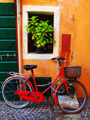 Traditional italian street with a red bicycles in Caorle old town. 