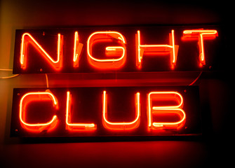 Nightclub neon sign hanging on the wall