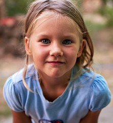 Little blond girl portrait outdoors
