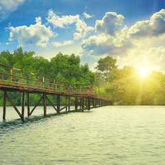 Wooden bridge over river. sunrise