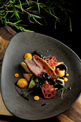 Haute cuisine/Asian fusion, roasted duck with plums and shiitake mushrooms